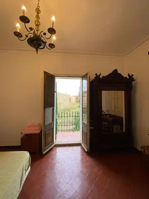 a bedroom with a bed and a mirror and a chandelier at Cal Llanto in Torrellas de Foix