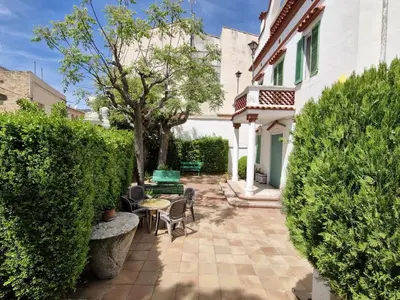 a courtyard of a house with a table and chairs at Cal Llanto in Torrellas de Foix