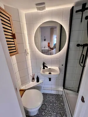 a bathroom with a sink and a toilet and a mirror at Cozy Barceloneta Beach Flat - Newly Renovated in Barcelona