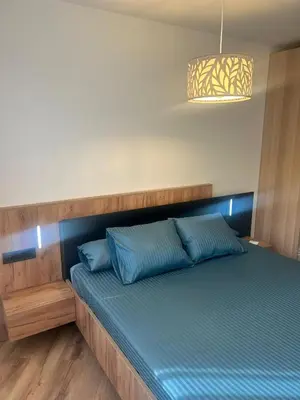 a bed with blue pillows in a room at Villa Montjuic Apartments in Barcelona