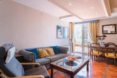 a living room with a couch and a table at Best sea views, 20 minutes to Barcelona in Montgat