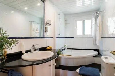 a white bathroom with a sink and a tub at Best sea views, 20 minutes to Barcelona in Montgat