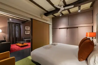 a bedroom with a bed and a living room at Stay U-nique Apartments Pou in Barcelona