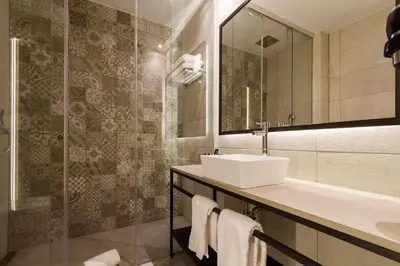 a bathroom with a sink and a mirror at Hotel Well and Come Barcelona in Barcelona