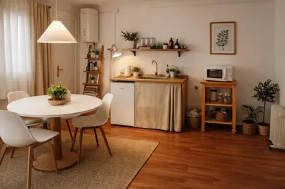 a kitchen and dining room with a table and a table and chairs at Affordable apartament & rooms in city center in Barcelona