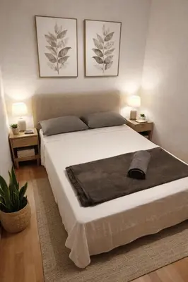 a bedroom with a large white bed with two lamps at Affordable apartament & rooms in city center in Barcelona