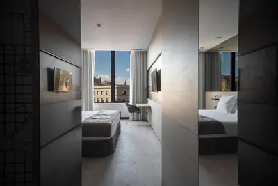 a hotel room with two beds and a window at Negresco Princess 4* Sup in Barcelona