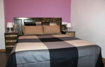a bedroom with a bed with two night stands and two lamps at Loft Sant Martí - Glories in Barcelona