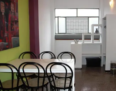 a dining room with a table and chairs and a window at Loft Sant Martí - Glories in Barcelona
