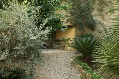 a garden with a bench in front of a building at Torre d'en Malla in Martorell