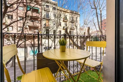 a dining room with a black table and chairs at Stylish Apartment with Balcony in Central Barcelona in Barcelona