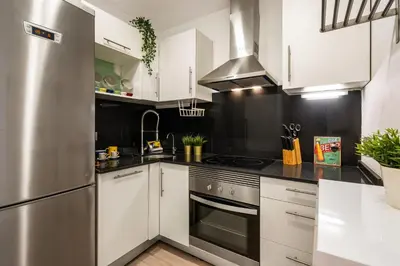 a washer and dryer in a room with a window at Stylish Apartment with Balcony in Central Barcelona in Barcelona
