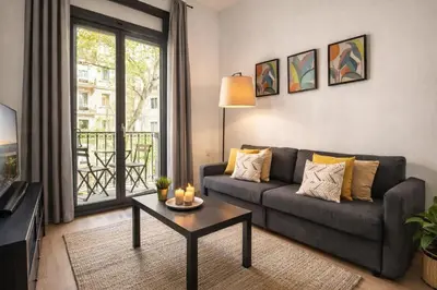 a room with a window with a table and a building at Stylish Apartment with Balcony in Central Barcelona in Barcelona