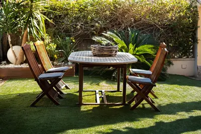 a patio with a blue couch and a table at Villa Rocamar by Hello Homes Sitges in Sitges
