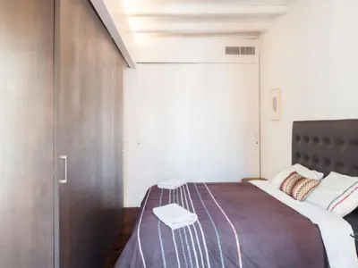 a bedroom with a large bed with a metal headboard at Design Apartment in Barcelona in Barcelona