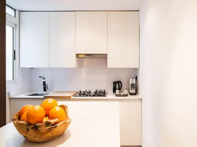 a bowl of oranges sitting on a counter in a kitchen at Design Apartment in Barcelona in Barcelona
