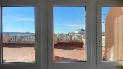 two windows with a view of a city through them at Ático premium Rambla Catalunya - Terraza 50 m2 in Barcelona