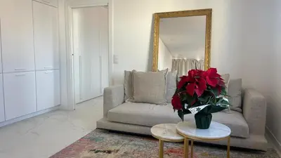 a living room with a couch and a mirror at Ático premium Rambla Catalunya - Terraza 50 m2 in Barcelona