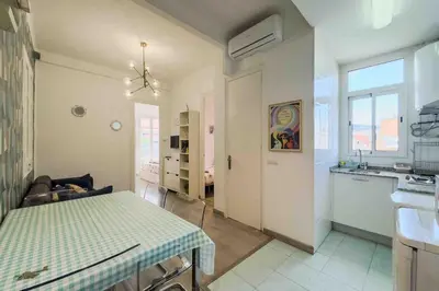 a living room with a table and a kitchen at Central apartment in Barcelona in Barcelona