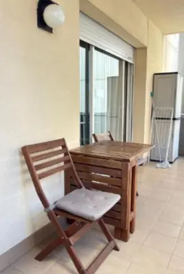a wooden table and chair in a room with a window at Entire Apartment in Barcelona, Camp Nou, Les Corts in Barcelona