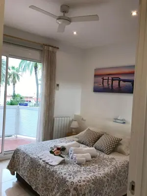 a bedroom with a bed with towels on it at Sitges Seafront RIBERA in Sitges