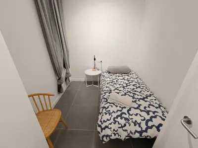 a room with a bed and a table and a chair at Lovely apartment Poblenou beach in Barcelona