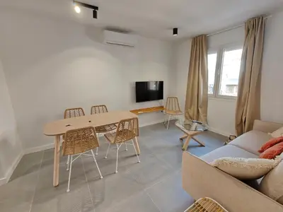 a living room with a table and chairs and a couch at Lovely apartment Poblenou beach in Barcelona