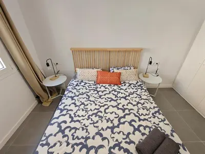 a bedroom with a bed and two night stands at Lovely apartment Poblenou beach in Barcelona