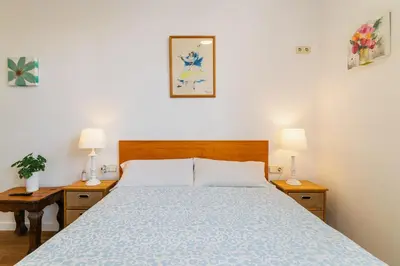a bedroom with a bed with two night stands and two lamps at Downtown penthouse with views of Barcelona in Barcelona