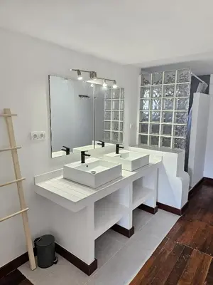 a bathroom with two sinks and a large mirror at La Casa Delviga in Can Trabal