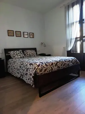 a bedroom with a bed with a black and white bedspread at Barcelona Eixample - Sagrada Familia - Monumental - City Center in Barcelona