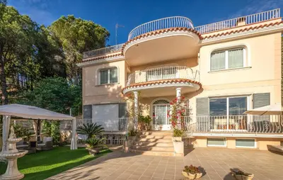 a large house with a balcony and a yard at Gorgeous Home In Arenys De Munt in Arenys de Munt