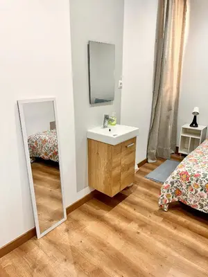 a bathroom with a desk and a chair and a sink at Habitación 4 zona centro in Barcelona