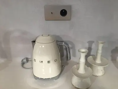 a white blender sitting on a counter with three vases at Born penthouse loft 1 in Barcelona