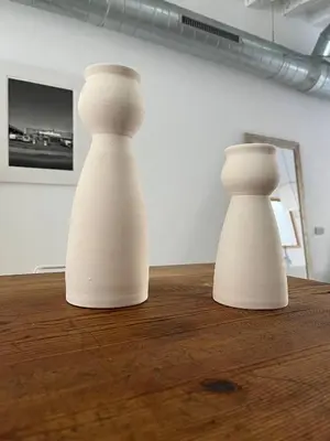 two white vases sitting on top of a wooden table at Born penthouse loft 1 in Barcelona