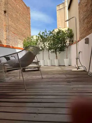 a patio with a chair and trees on a building at Born penthouse loft 1 in Barcelona