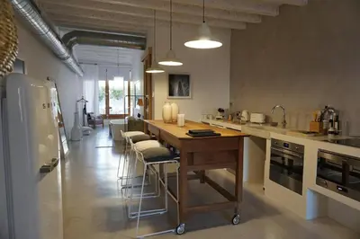 a kitchen with a table and some chairs in it at Born penthouse loft 1 in Barcelona