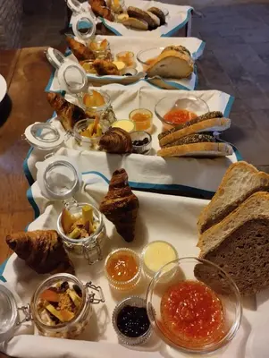 a table topped with different types of sandwiches and bread at Antic Can Poi - Masia histórica del siglo XIII en la Garriga in La Garriga