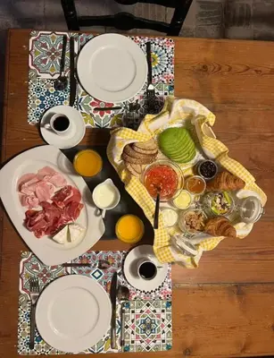 a table with plates of food on a table at Antic Can Poi - Masia histórica del siglo XIII en la Garriga in La Garriga