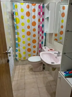 a bathroom with a toilet and a sink and a shower curtain at Mirian in Barcelona