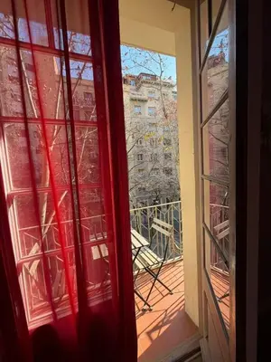 an open window with a view of a balcony at Cozy Apartment in the Center Area Sagrada Familia in Barcelona
