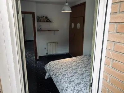 a bedroom with a bed and a mirror in a room at Habitaciones Carmen in Rubí