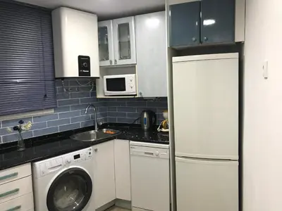 a kitchen with a white refrigerator and a dishwasher at Estancia perfecta, apartamento bonito in Hospitalet de Llobregat