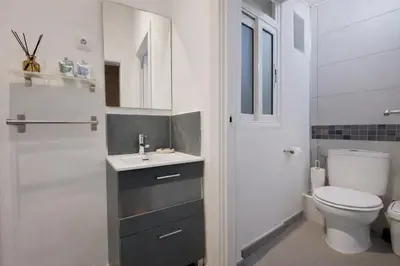 a white bathroom with a sink and a toilet at Boutique Murillo in Barcelona