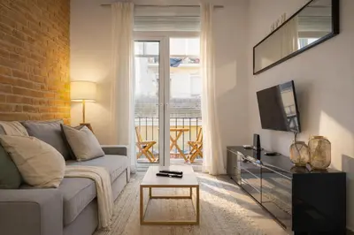 a living room with a couch and a tv at Boutique Murillo in Barcelona