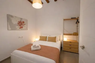 a bedroom with a bed with two towels on it at Boutique Murillo in Barcelona