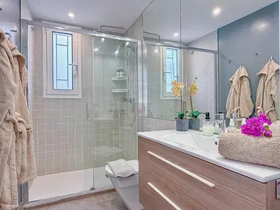 a bathroom with a shower and a sink at Bonaire Penthouse Sitges 2 terraces steps from beach in Sitges