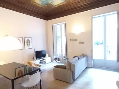 a living room with a couch and a table at Catalan Music Palace with private terrace in Barcelona