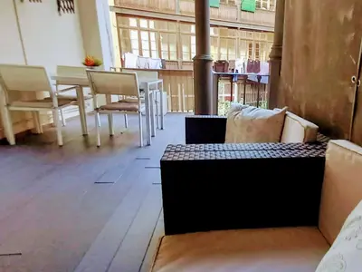 a room with a couch and a table and chairs at Great location with private terrace in Barcelona