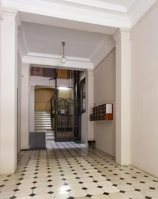a hallway with a door and a tiled floor at Great location with private terrace in Barcelona
